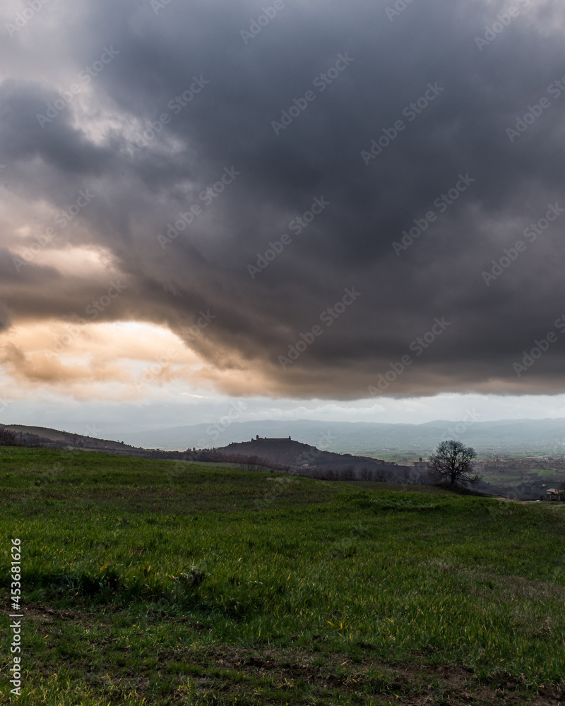 Moody, big rainy clouds above Assisi, Umbria, Italy Moody, big rainy clouds above Assisi, Umbria, Italy