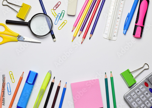 Back to school, variety of material. Central area for copy space, white background.
