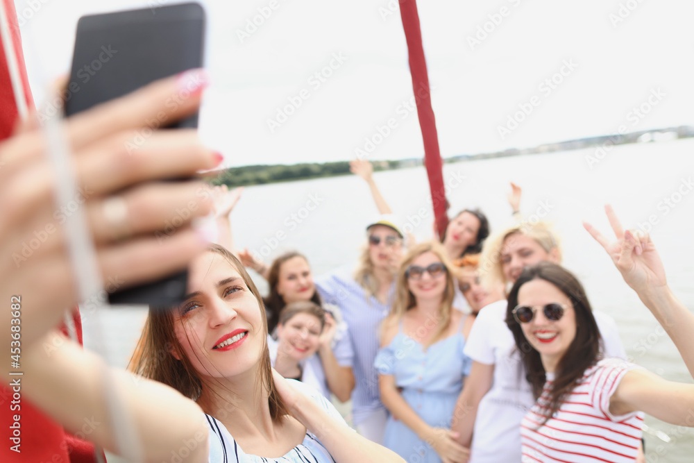 Cheerful women on board the boat take a selfie