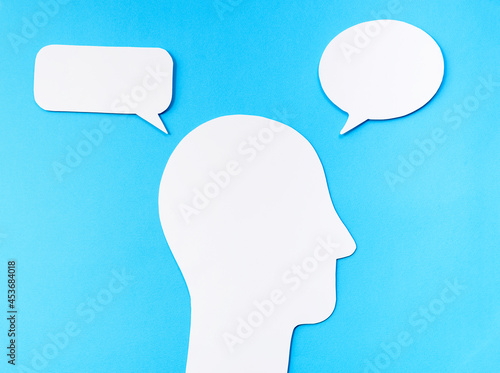 Inner dialogue concept. Soliloquy. head silhouette made of paper with two speech bubbles