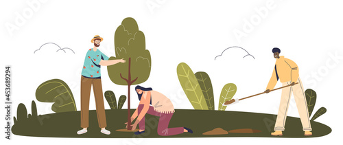 Team of volunteers planting trees in park or forest to save planet from deforestation