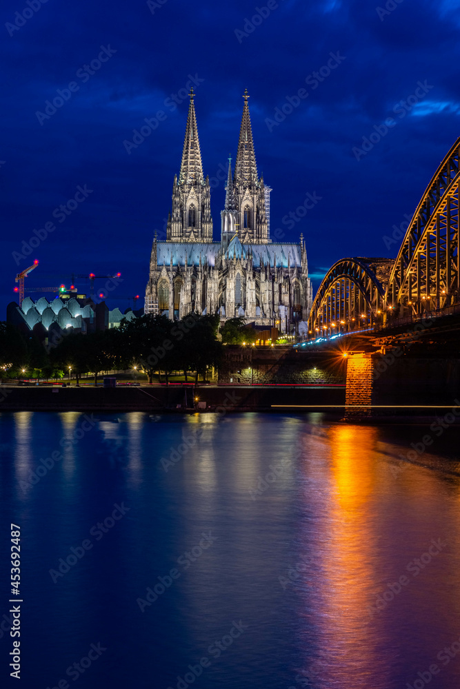 COLOGNE, GERMANY, 23 JULY 2020 Night view of Cologne Cathedral and Hohenzollern Bridge