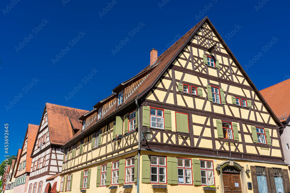 Fototapeta premium DINKELSBUHL, GERMANY, 27 JULY 2020: Colorful and ancient half-timbered houses in the historic center