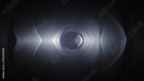 Stylish caustic screensaver for smartphone. Beautiful designed animation with flashes of light and lens flare on black background. photo