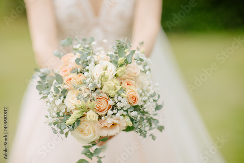 Bride holds a boho bridal bouquet with eucalyptus
