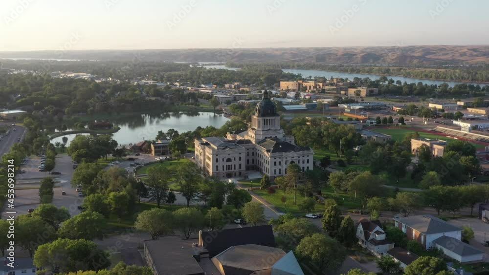 South Dakota state Capitol building in Pierre, SD. Wide aerial drone footage of state government buildings.