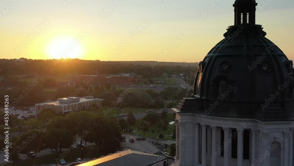 State Capitol building in Pierre, South Dakota. Drone shot flying backwards past the domed roof of the statehouse.