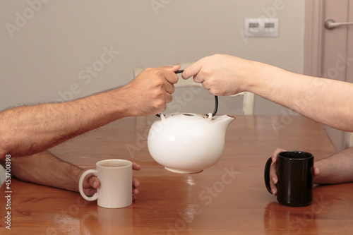 Two young caucasian men sharing a hot beverage