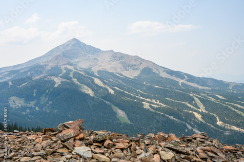 View of Lone Mountain peak and sky runs, in the summer, from the peak across the valley, Big Sky, Montana
 photo