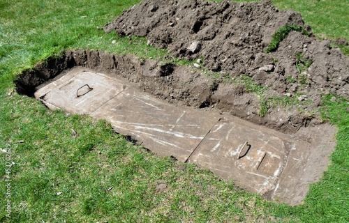 A home septic tank uncovered and ready for maintenance.