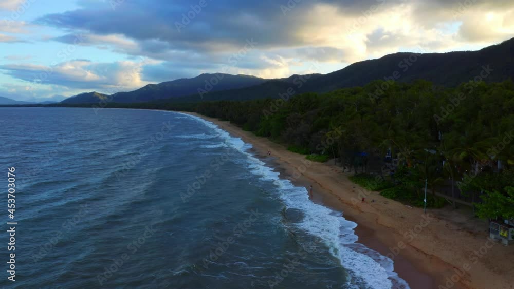 Aerial View Of Coral Sea Waves Splashing On Sandy Beach In Palm Cove, Cairns Region, Queensland, Australia With Overcast. Aerial View Of Coral Sea Waves Splashing On Sandy Beach In Palm Cove, Cairns Region, Queensland, Australia With Overcast.