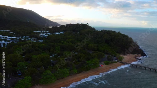 Beautiful Coastal Village With Green Vegetation At Palm Cove Beach In Cairns, Queensland, Australia. - Aerial Drone Shot photo