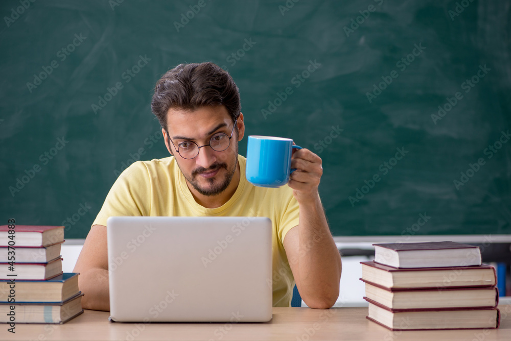 Young male student preparing for exams in the classroom Young male student preparing for exams in the classroom