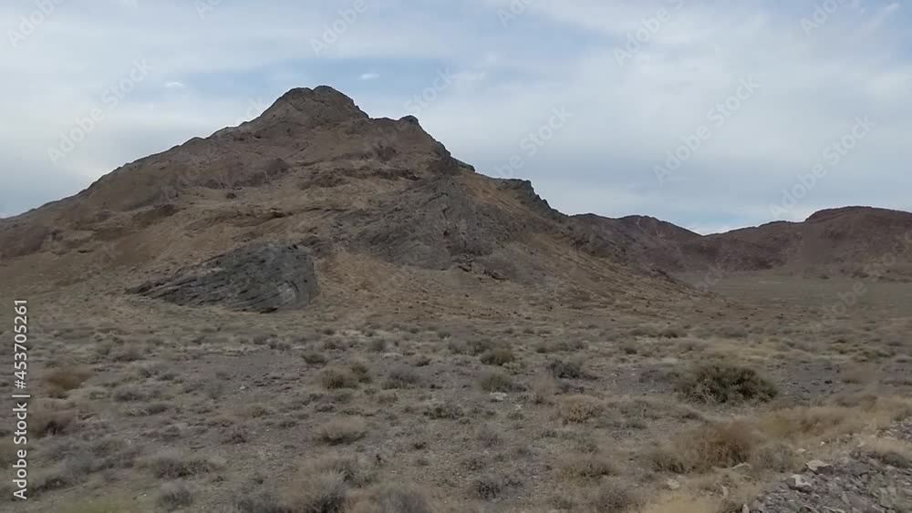 Huge barren mountain in Utah prairie. Shot from a fast moving car Huge barren mountain in Utah prairie. Shot from a fast moving car