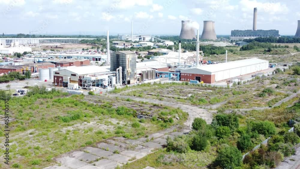 Industrial warehouse power plant refinery buildings under smokestack wasteland aerial view zoom in Industrial warehouse power plant refinery buildings under smokestack wasteland aerial view zoom in