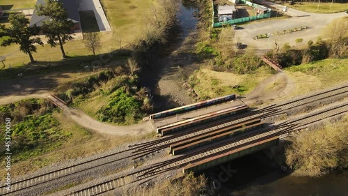 AERIAL - Person jogging next to railway and river in Maschwitz, Argentina photo