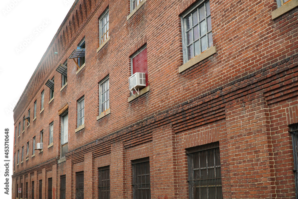 perspective view of old brick wall and window of old factory building