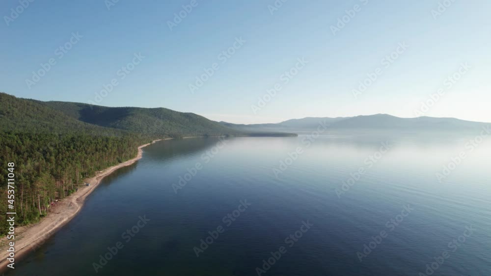 Summer morning aerial landscape of Lake Baikal is a rift lake located in southern Siberia, Russia Baikal lake summer landscape view. Drone's Eye View. Summer morning aerial landscape of Lake Baikal is a rift lake located in southern Siberia, Russia Baikal lake summer landscape view. Drone's Eye View.