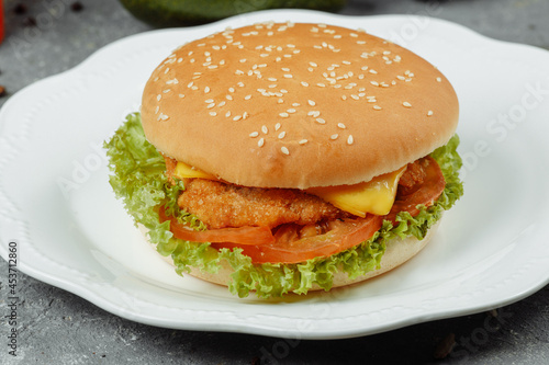 hamburger with fries and salad on the plate