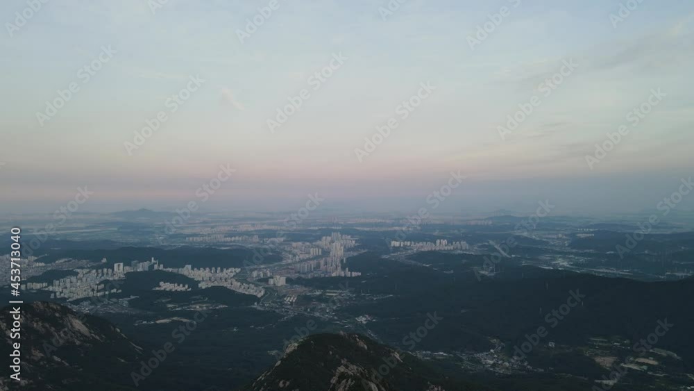 Beautiful aerial shot of Seoul city and mountains at sunrise in South Korea Beautiful aerial shot of Seoul city and mountains at sunrise in South Korea