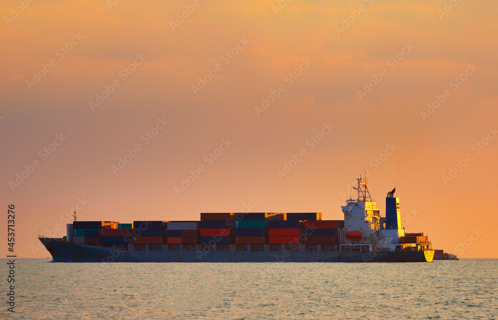 Container ship carrying container box in import export with quay crane, Global business cargo freight shipping commercial trade logistic and transportation oversea worldwide by container vessel. Container ship carrying container box in import export with quay crane, Global business cargo freight shipping commercial trade logistic and transportation oversea worldwide by container vessel.