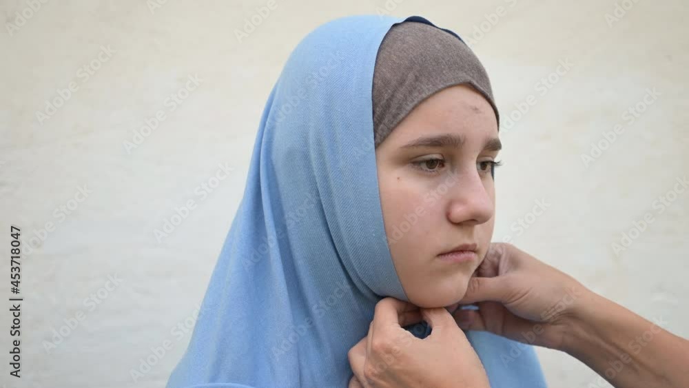 portrait of a homeless refugee teenage girl dressed in a blue headscarf portrait of a homeless refugee teenage girl dressed in a blue headscarf