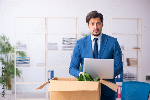 Young male employee in business relocation concept