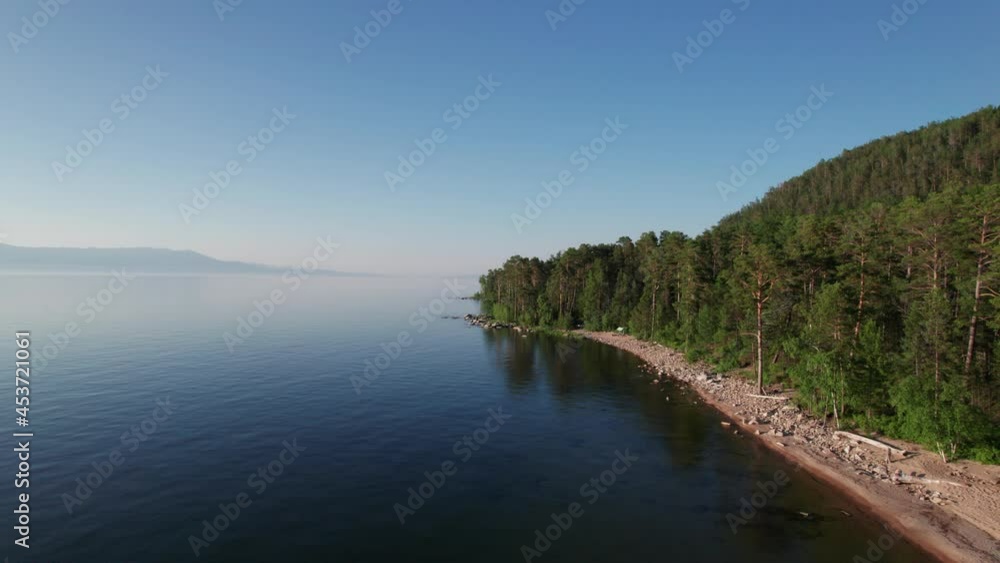 Summer evening aerial landscape of Lake Baikal is a rift lake located in southern Siberia, Russia Baikal lake summer landscape view. Drone's Eye View. Summer evening aerial landscape of Lake Baikal is a rift lake located in southern Siberia, Russia Baikal lake summer landscape view. Drone's Eye View.