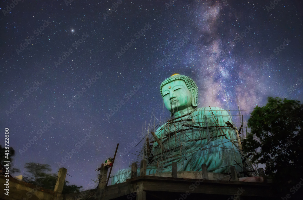 Daibutsu or 'Giant Buddha' is a Japanese term often used informally for a large statue of Buddha, Giant Buddha with milky way in sky at night, Mae Tha District, Lampang Province