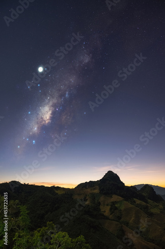 Milky Way galaxy with stars at night in mountain forest and sunrise. © 24Novembers