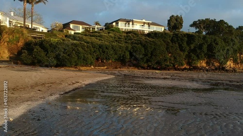 low flying drone footage of Beach at low tide with reflections in still water. photo