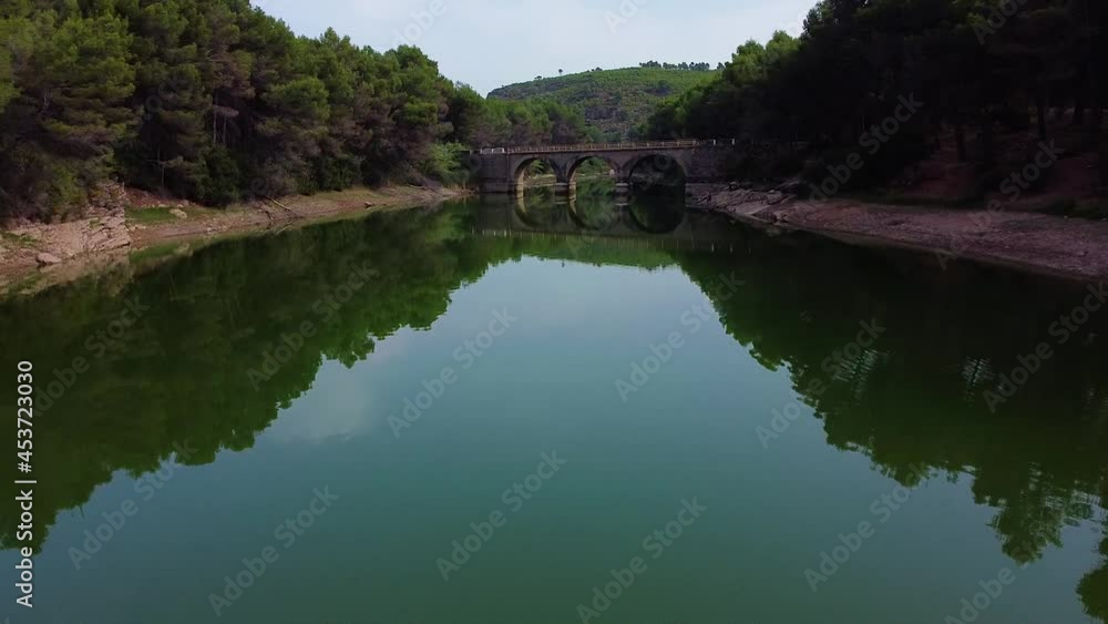 Small Bridge Spanning Ulldecona Dam With Reflections In Castellon, Spain. dolly-in Small Bridge Spanning Ulldecona Dam With Reflections In Castellon, Spain. dolly-in