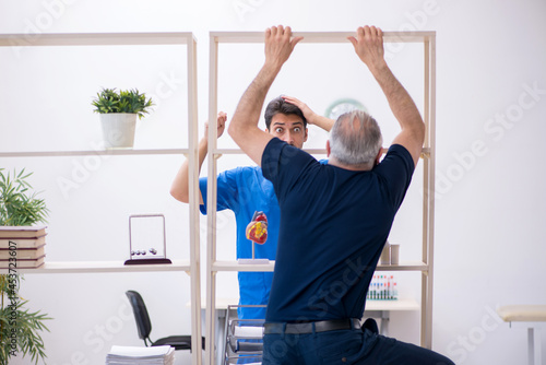 Old man visiting young male doctor