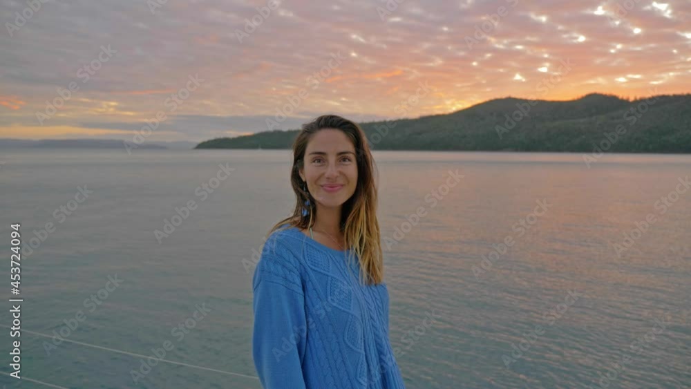 Young Caucasian Woman Admiring Calm Sea And Beautiful Sky During Sunset - Whitsunday Island In QLD, Australia. - medium shot Young Caucasian Woman Admiring Calm Sea And Beautiful Sky During Sunset - Whitsunday Island In QLD, Australia. - medium shot