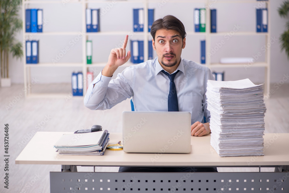 Young businessman employee unhappy with excessive work in the of Young businessman employee unhappy with excessive work in the of