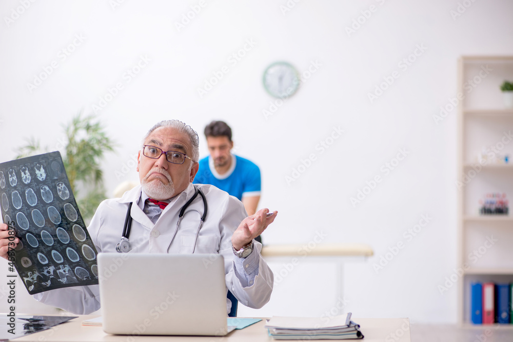 Young male patient visiting old male doctor radiologist