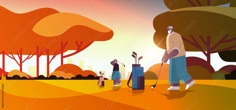 Fototapeta premium senior people playing golf on green golf course aged african american players taking a shot active old age