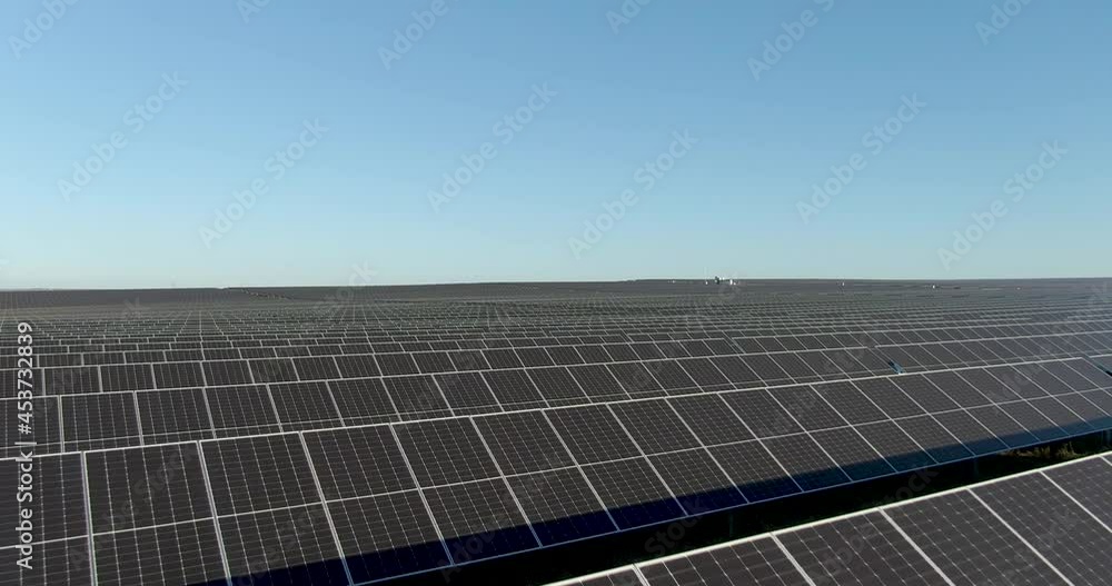 Ecology solar power station panels in sunny outdoor fields. Using green energy in huge landscape electrical innovation nature environment slow motion. Ecology solar power station panels in sunny outdoor fields. Using green energy in huge landscape electrical innovation nature environment slow motion.