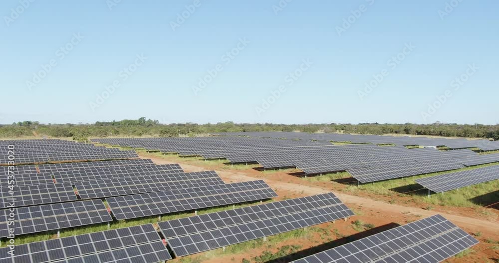 Aerial view of Solar Panels Farm with sunlight. Drone fly over solar panels field. Renewable green alternative energy Aerial view of Solar Panels Farm with sunlight. Drone fly over solar panels field. Renewable green alternative energy