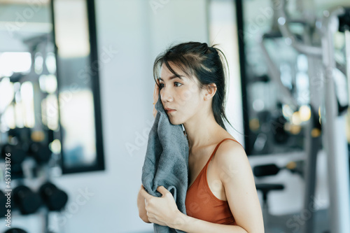 sport woman resting after workout and wipe the sweat by towel. sport and workout concept. Free Download sport woman resting after workout and wipe the sweat by towel. sport and workout concept. - GFXLoad