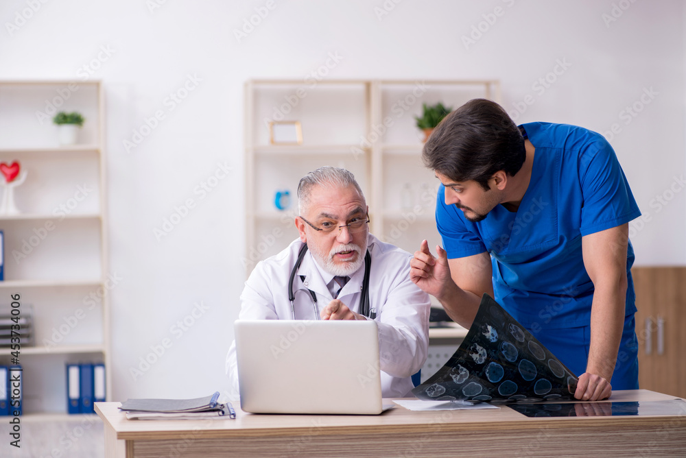 Two male doctors working in the clinic Two male doctors working in the clinic