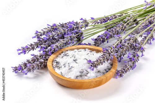 Lavender sea salt with a bunch of lavandula flowers, aromatic herb for cooking or a bath salt for spa, on a white background