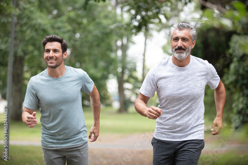 athletic men running in the nature healthy lifestyle