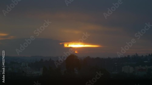 Golden sunset in Addis ababa, with thick clouds and the rays through them. photo