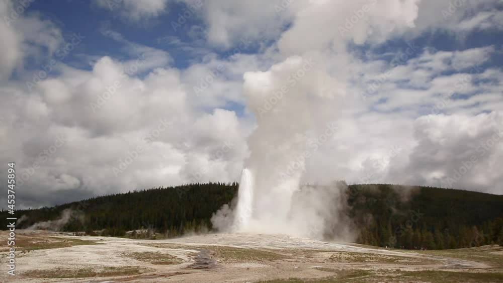 Old Faithful geyser Yellowstone National Park erupting blue sky Old Faithful geyser Yellowstone National Park erupting blue sky