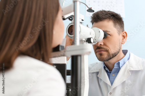 Fototapeta Naklejka Na Ścianę i Meble -  Ophthalmologist examining young woman in clinic