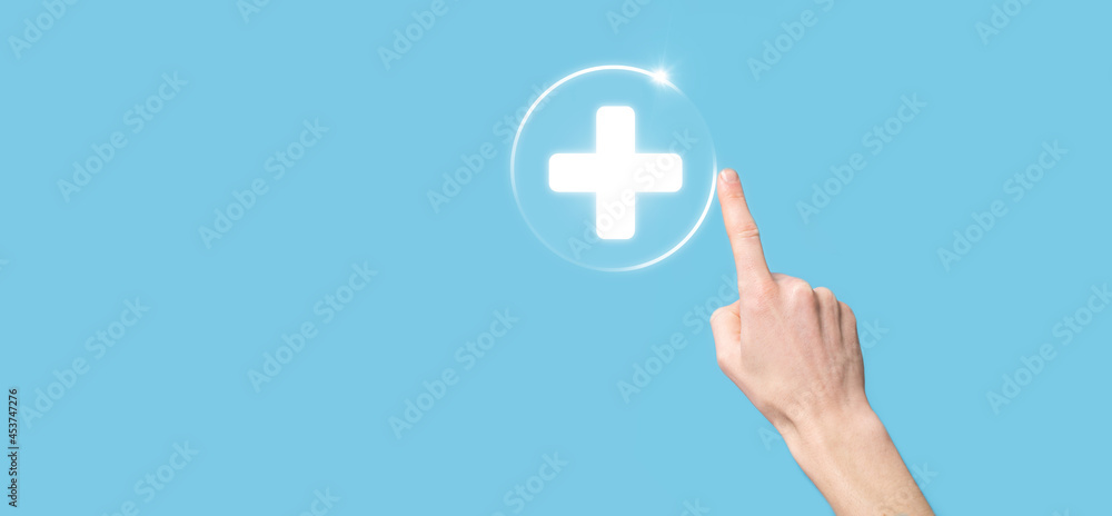 Businessman hold virtual plus medical network connection icons. Covid-19 pandemic develop people awareness and spread attention on their healthcare. Businessman hold virtual plus medical network connection icons. Covid-19 pandemic develop people awareness and spread attention on their healthcare.