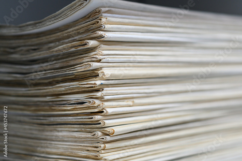 Close up corner of old newspapers folded stacked