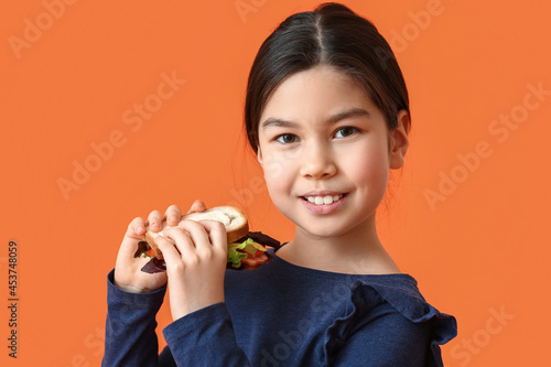 Little girl with tasty sand...