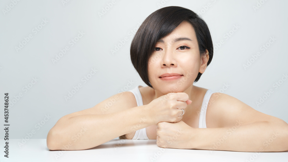 Skin radiance concept. Portrait of a beautiful 30s asian woman in white inner wear with flawless face, shiny healthy hair. K-beauty, Collagen, Products, Clinic, Plastic surgery, V shape, Skincare, 40s Skin radiance concept. Portrait of a beautiful 30s asian woman in white inner wear with flawless face, shiny healthy hair. K-beauty, Collagen, Products, Clinic, Plastic surgery, V shape, Skincare, 40s